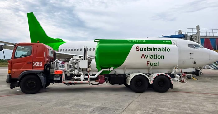 An airplane being fueled by a fuel truck labeled Sustainable Aviation Fuel.