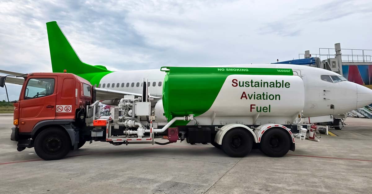 An airplane being fueled by a fuel truck labeled Sustainable Aviation Fuel.