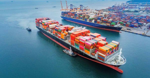 Two shipping cargo vessels at a port.