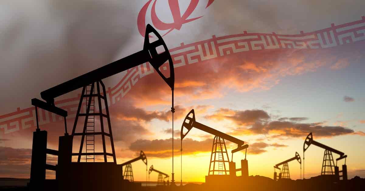 Silhouette of oil pumps against the sunset with flag of Iran.