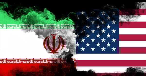 US and Iran flags with an overlay of smoke.