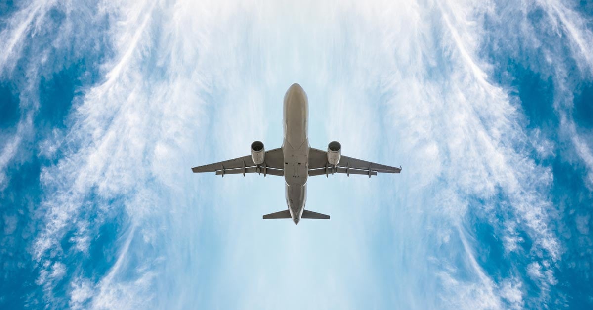 Upward look of an airplane flying in the sky.