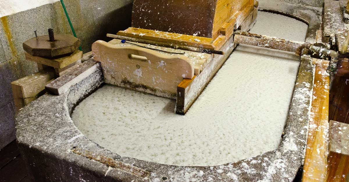 Interior of a pulp mill, with a large container of pulp mixing together.
