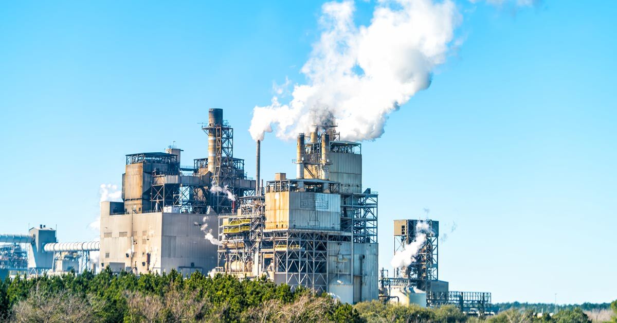 Exterior shot of an industrial paper mill while operating.