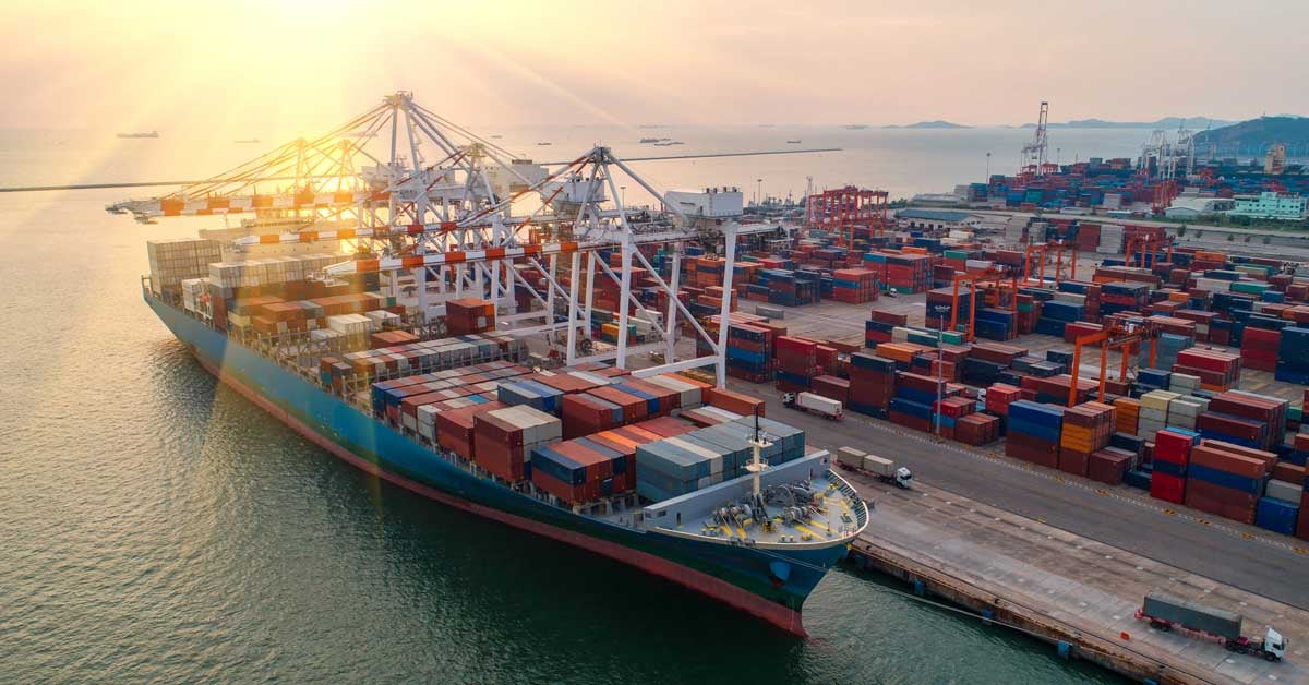 A commercial vessel at a busy shipping port.