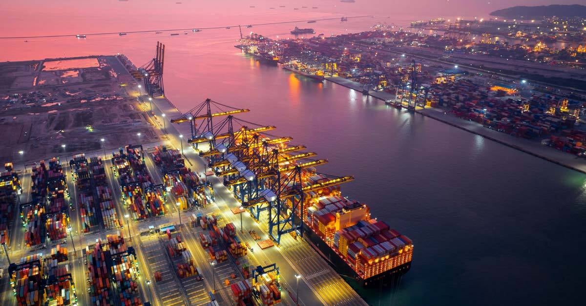Aerial view of cargo ship and cargo container in harbor.