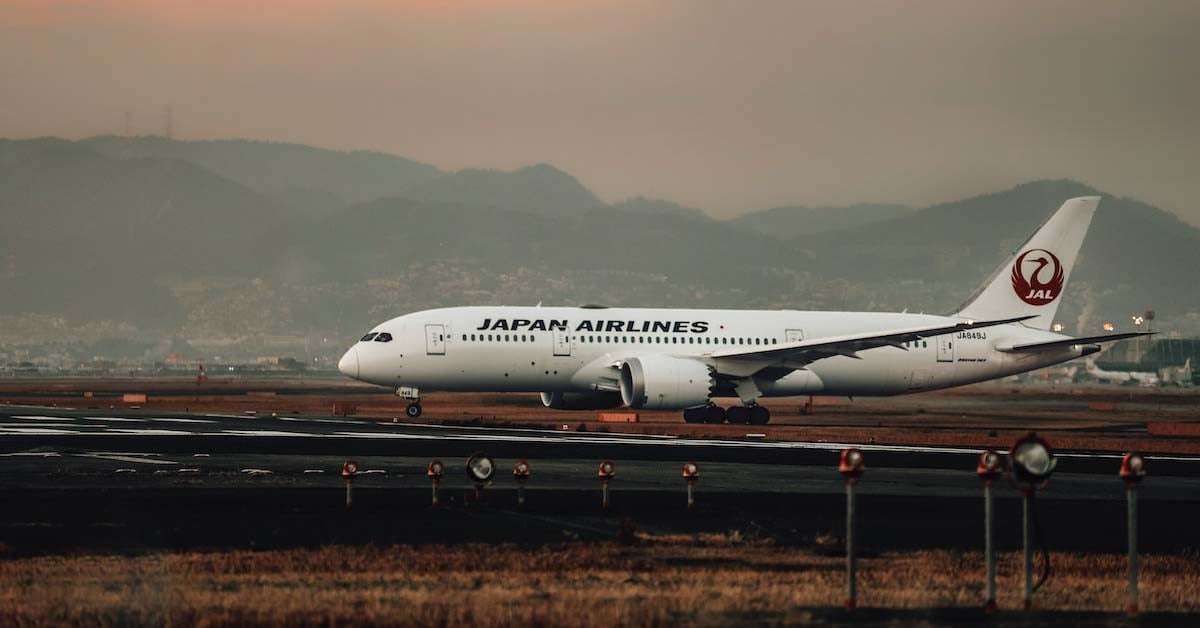 Japan Airlines plane landing on a runway.