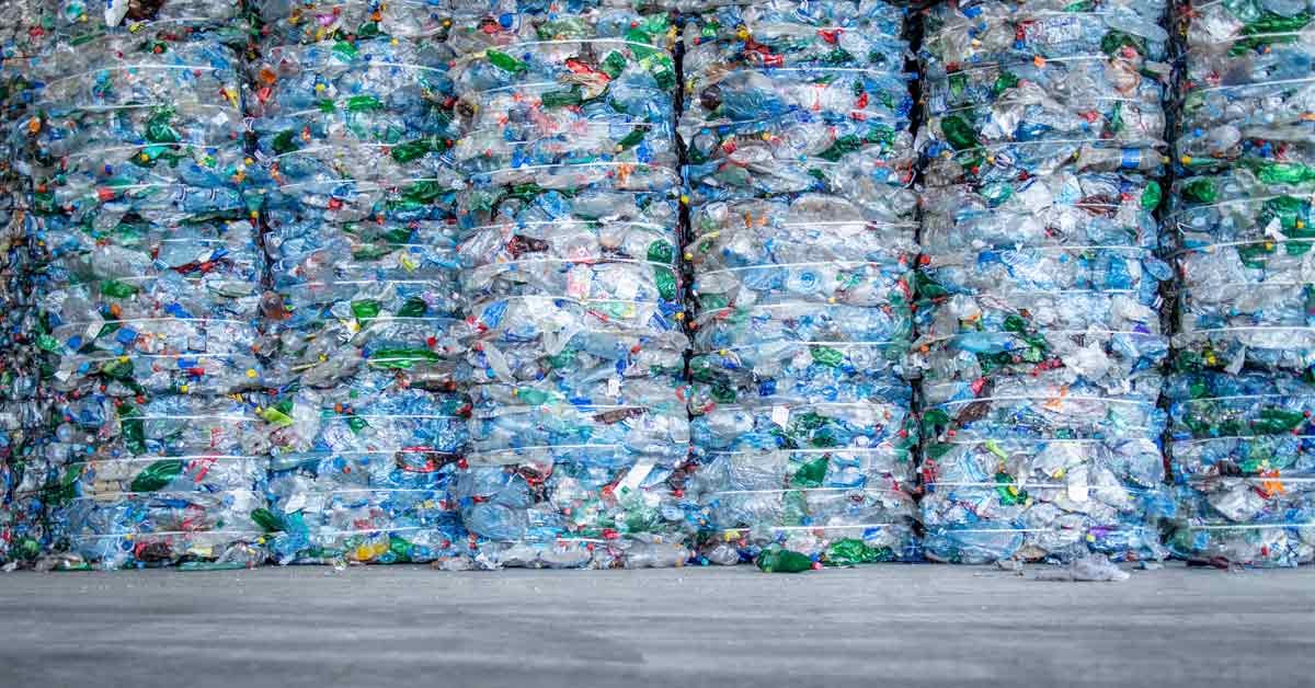 Several tons of plastic bound up and stacked, ready to be converted into recycled carbon fuel.