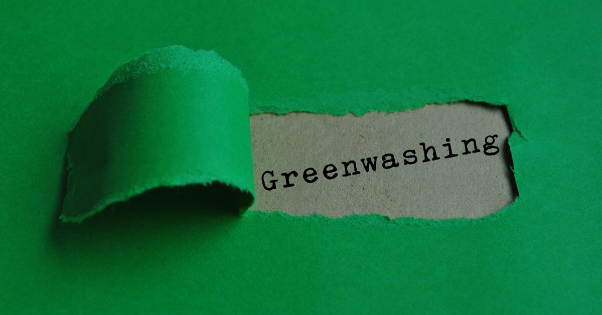 A green piece of construction paper torn away in the center revealing the word 'greenwashing' denoting airlines greenwashing carbon emmisions.
