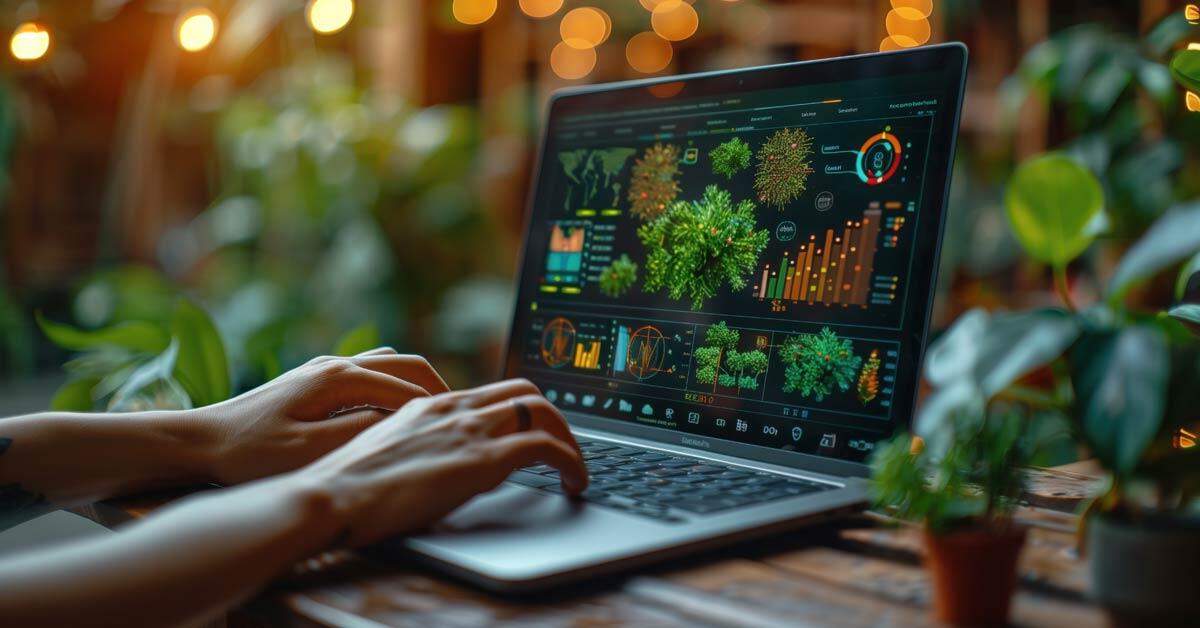 A person's hands working on a laptop with sustainability reporting.