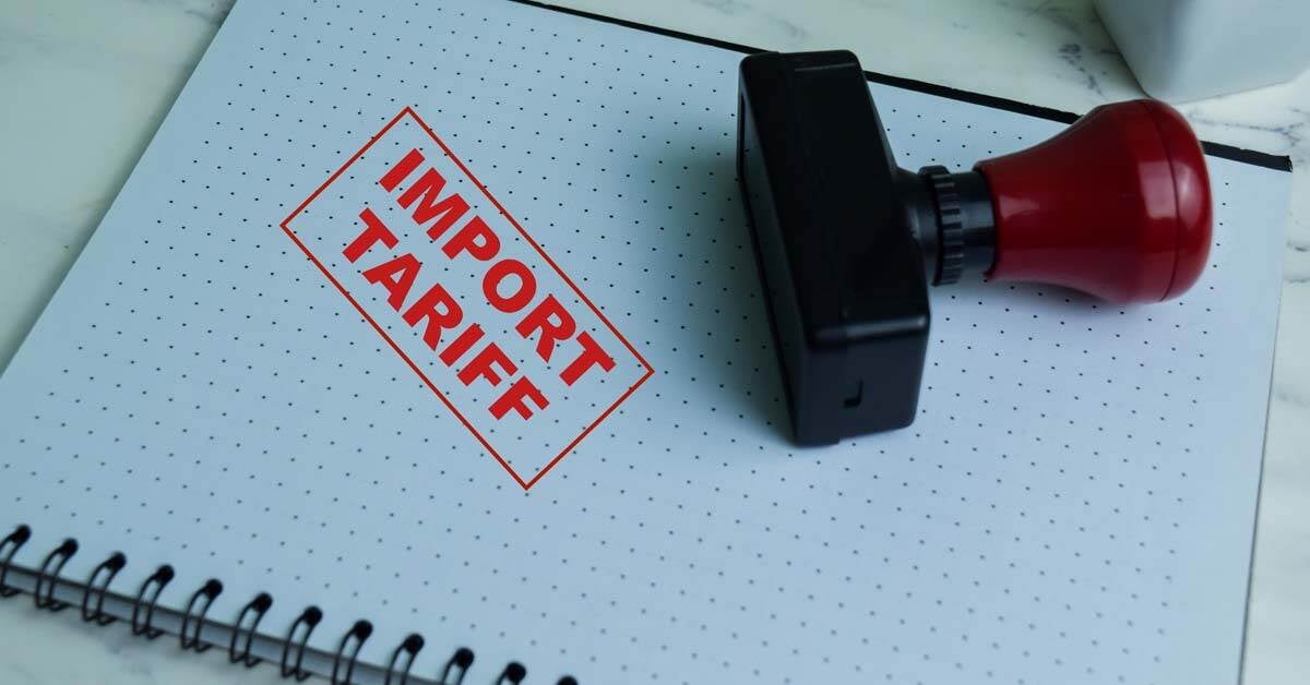 Stamp that has the words Import Tariff stamped on a notebook.