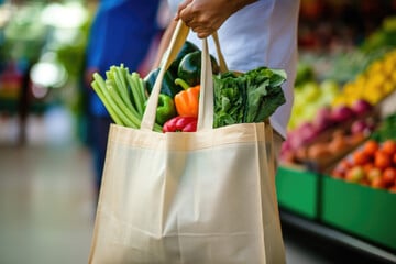 A reusable grocery bag filled with produce.