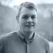A black and white headhshot photograph of Matthew Stone from Prima Markets. 