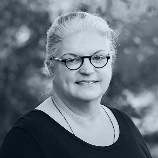 A black and white headshot of Suz-Anne Kinney.