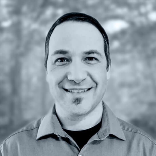 Headshot of Greg Stone in black and white.