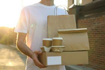 Man delivering food in paper packaging.