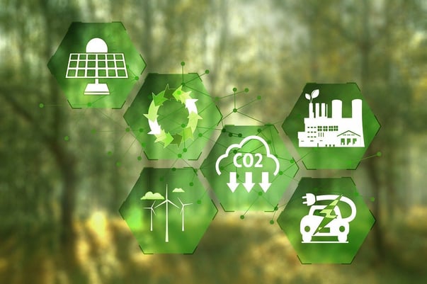 Graphical depiction of low carbon markets with icons of a green energy factory, EV, CO2 reduction and solar panel.
