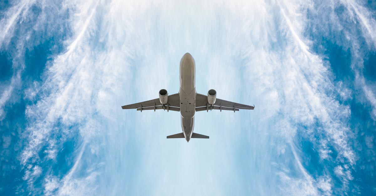 Upward look of an airplane flying in the sky.