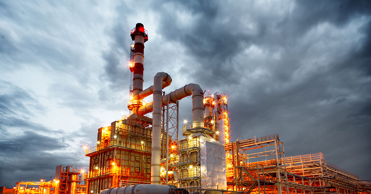 Photo of a chemical refinery with cloudy skies