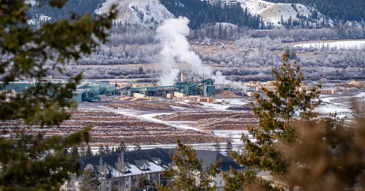 Citycape view of Radium Hot Springs, British Columbia, with a view of a lumber mill.